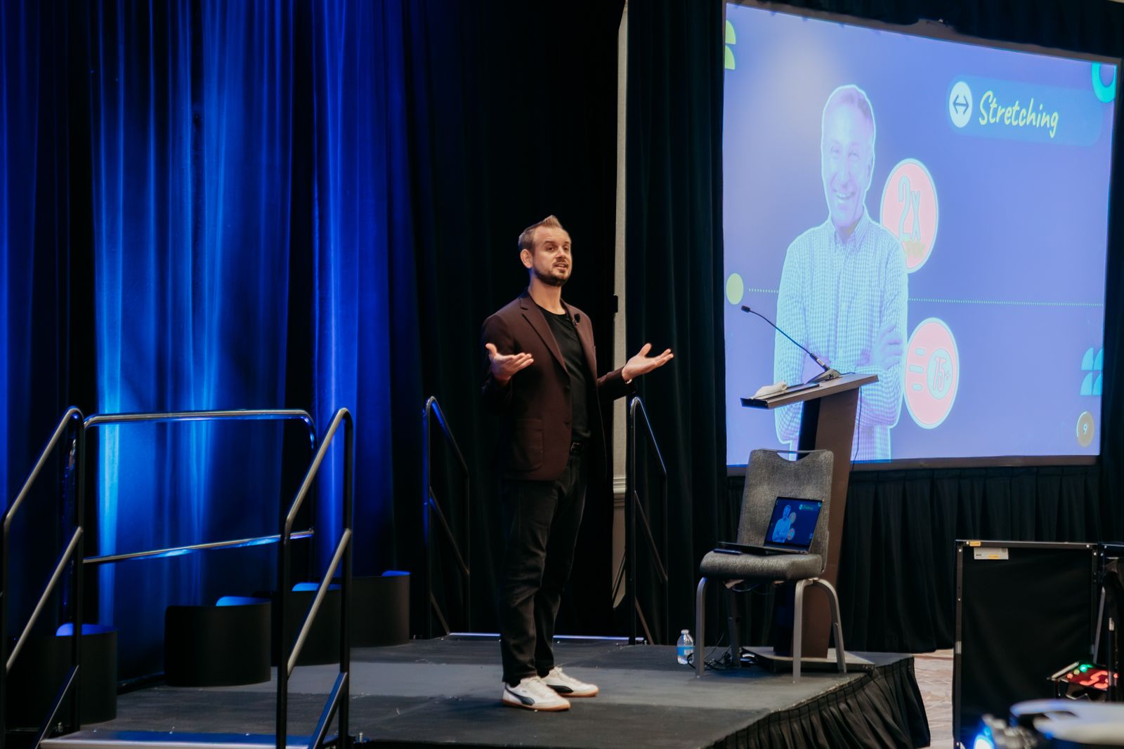 Luke presenting on stage