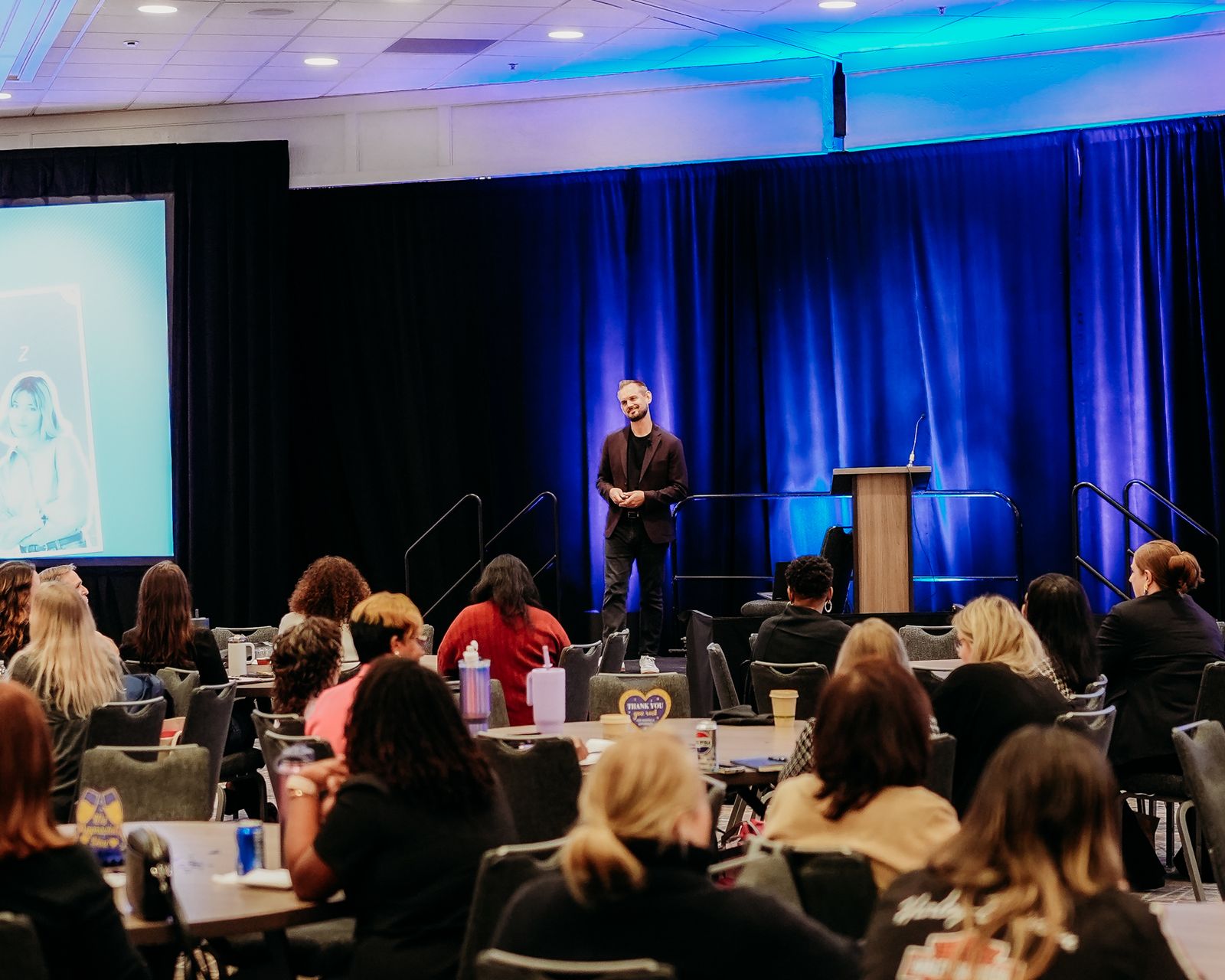 Luke on stage with audience